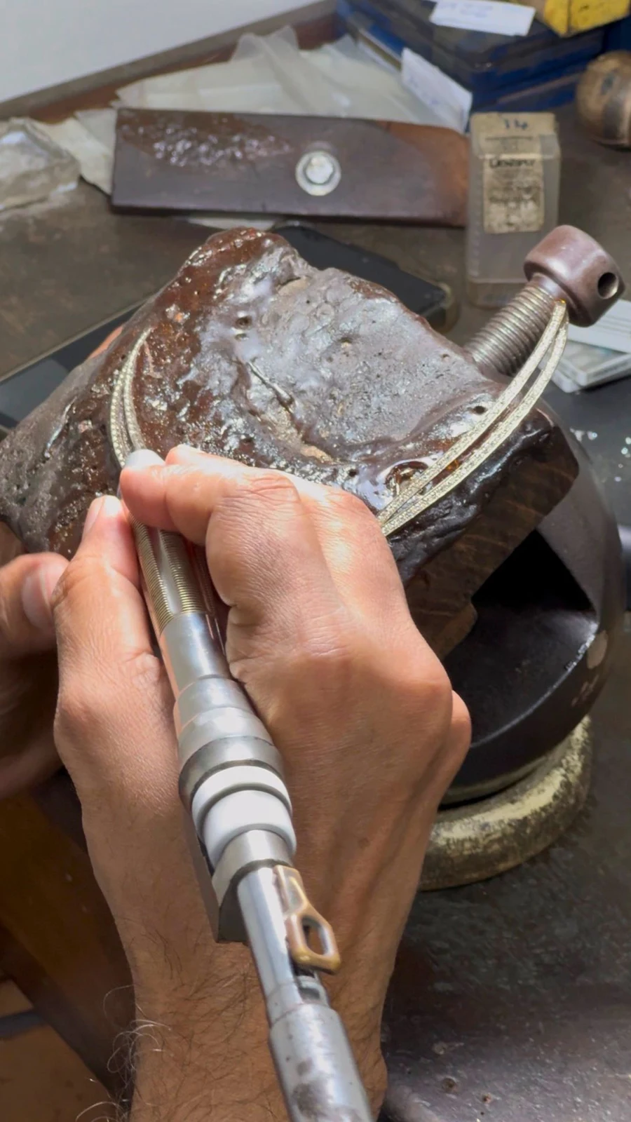 Jewellery being worked by hand at a workshop bench