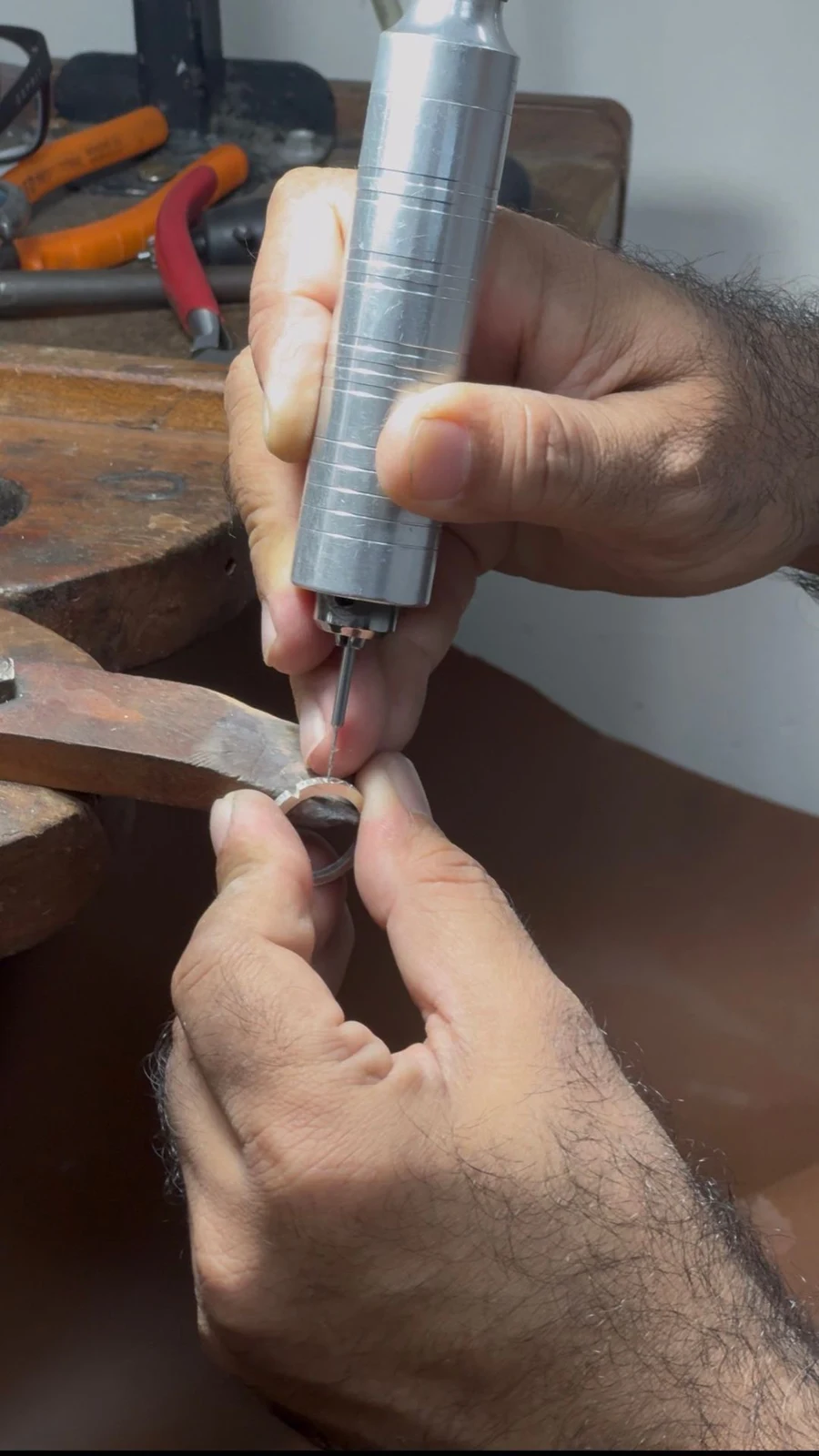 A jewellery piece held with a precision tool